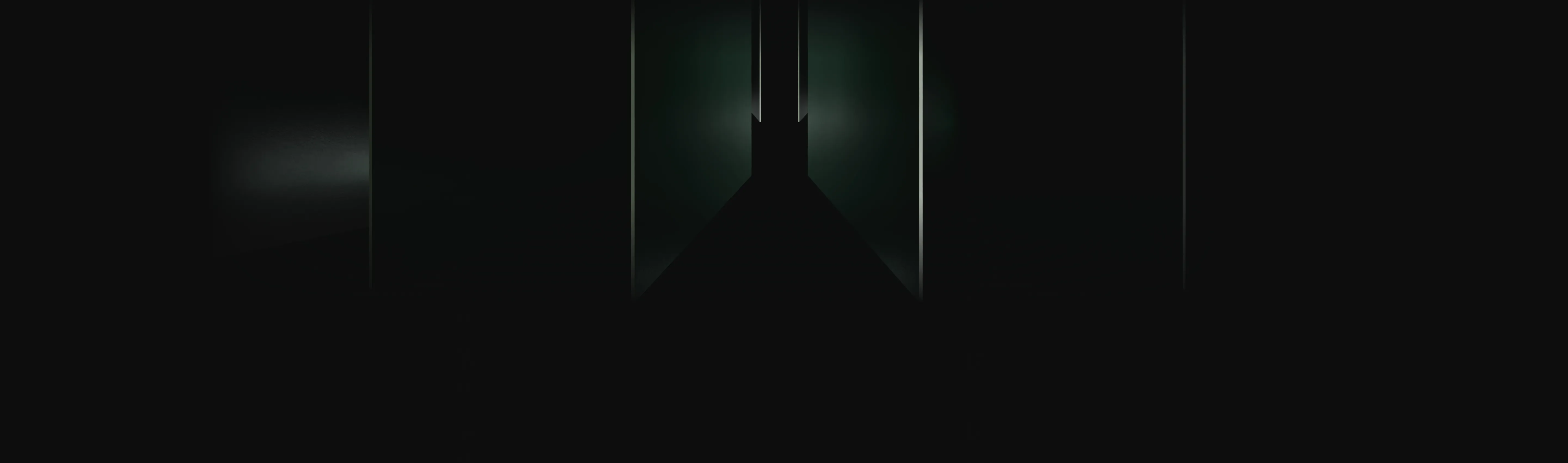 Dark, narrow hallway with faint light illuminating the far end and walls.