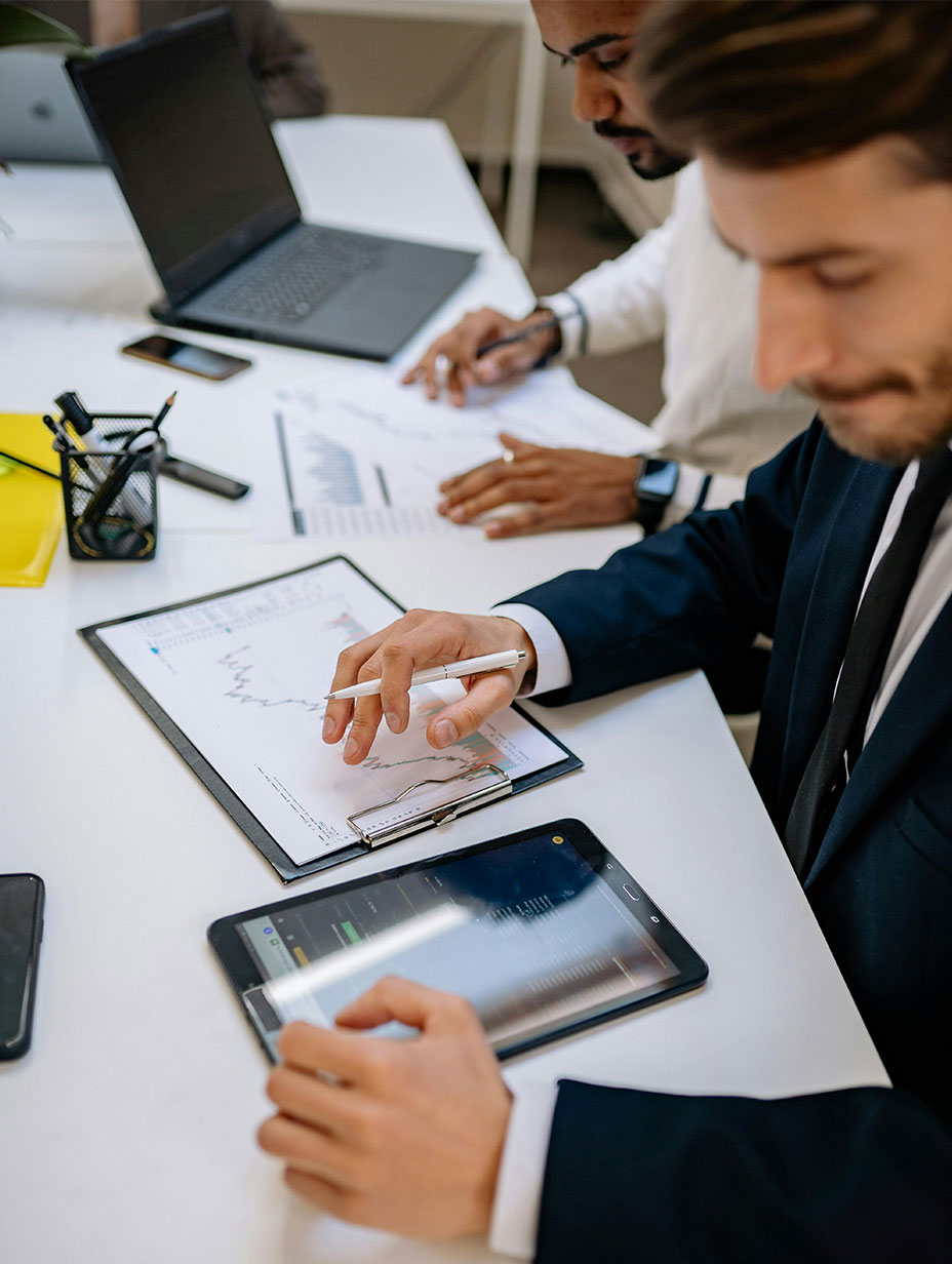 Two compliance specialists working on an account