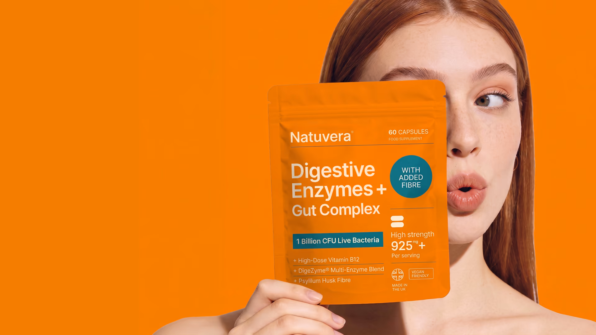Red-haired woman holding Natuvera Metabolic Support Complex supplement pouch near her face.