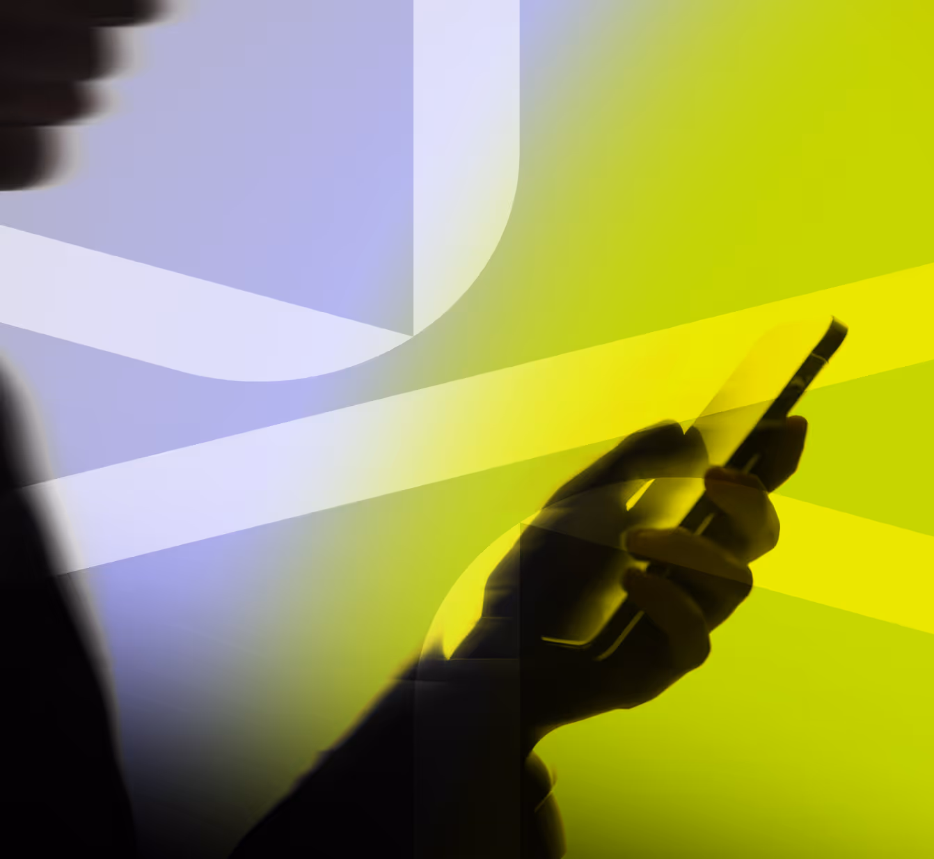 Silhouette of a hand holding and interacting with a smartphone against a background of abstract yellow and blue light beams.