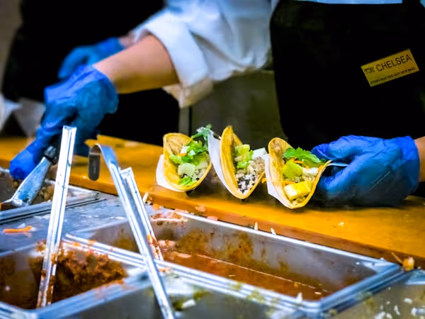 A Wegmans chef prepares tacos during the Grand Opening