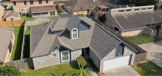 Flat commercial building roof with white membrane, ventilation units, and skylights.