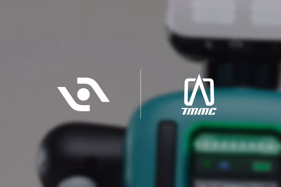 Agility Robotics logo and TMMC logo side by side over a blurred background with teal and black colors.