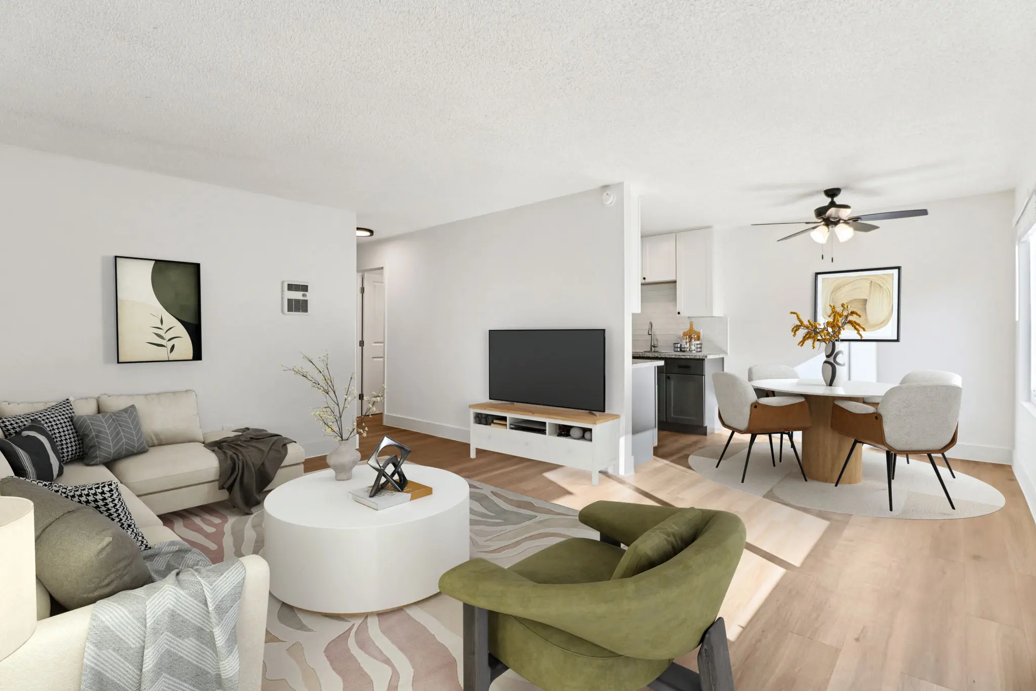 Spacious living area with sofa chairs, coffee table, tv, and view of fining area with table and chairs