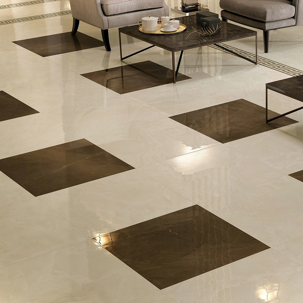 Glossy beige floor tiles with large dark brown square insets in a living room with modern furniture.