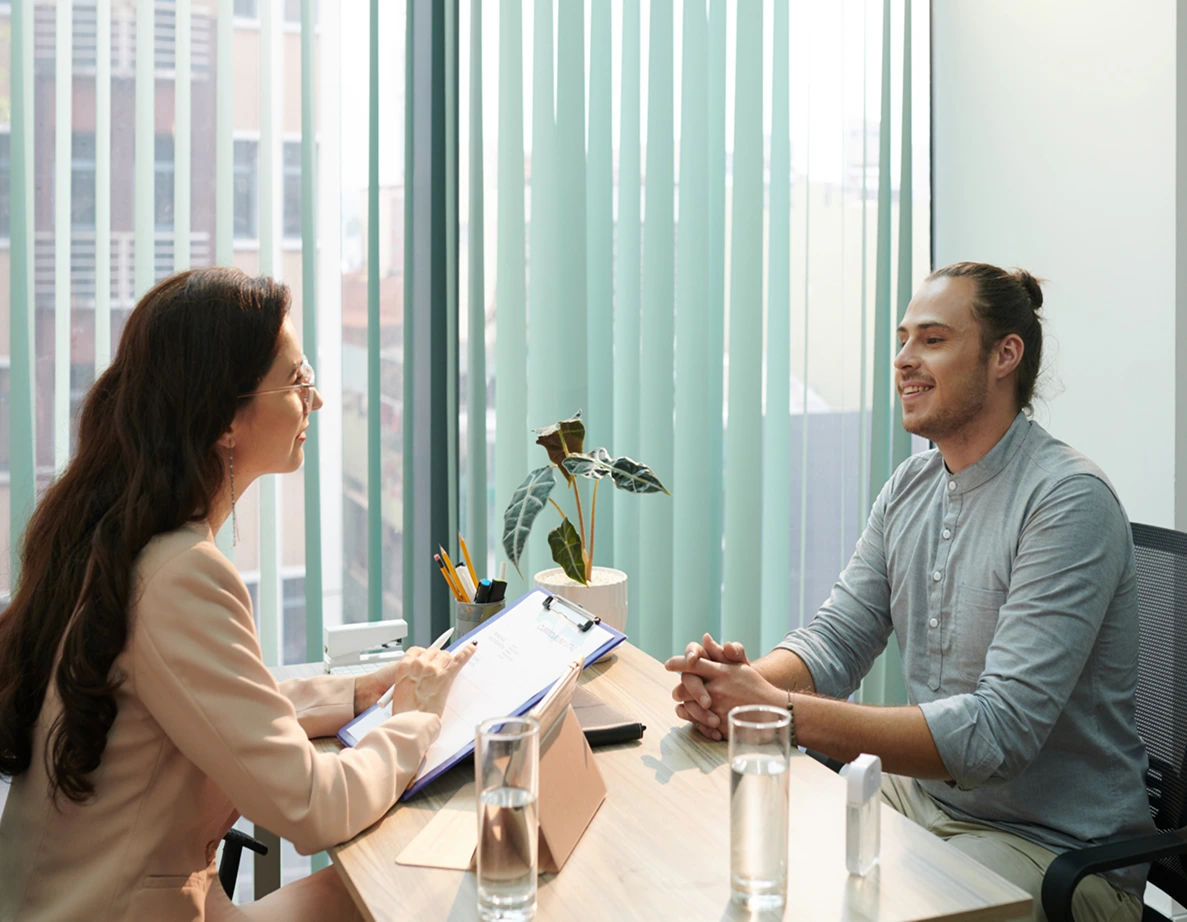 Header image of recruiter talking at desk