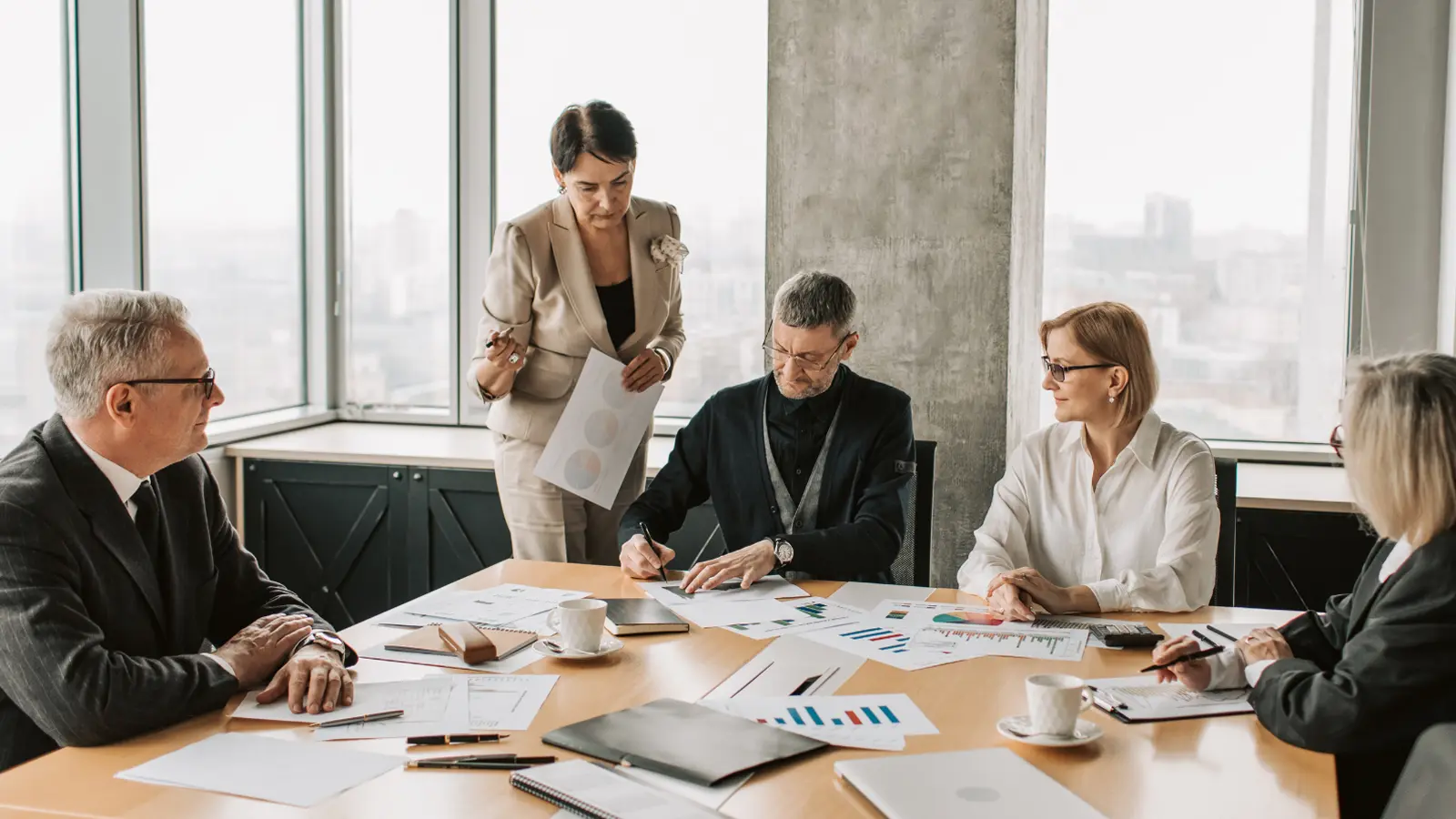 Workers at table examining company details