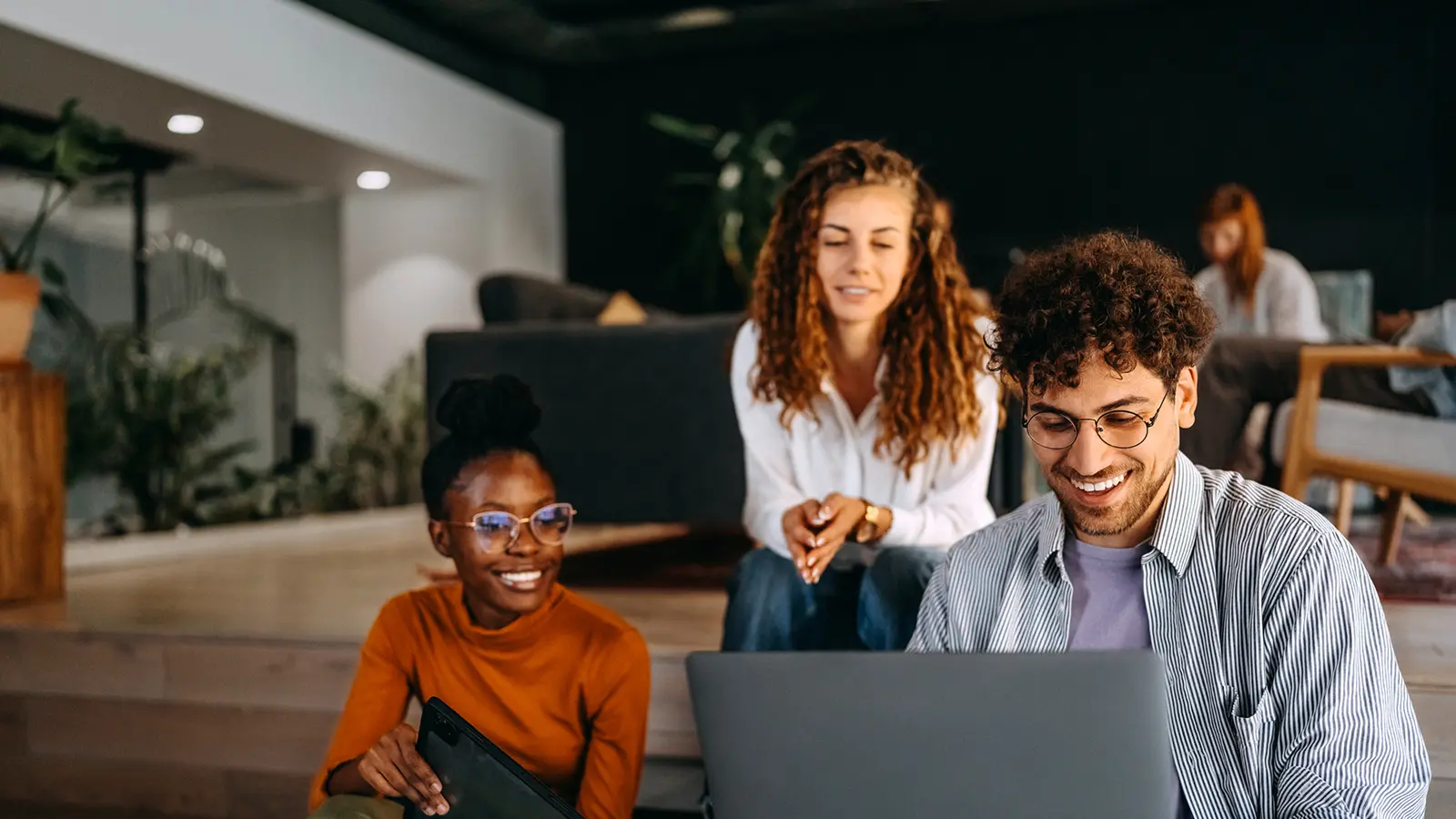 Coworkers sitting at computer 