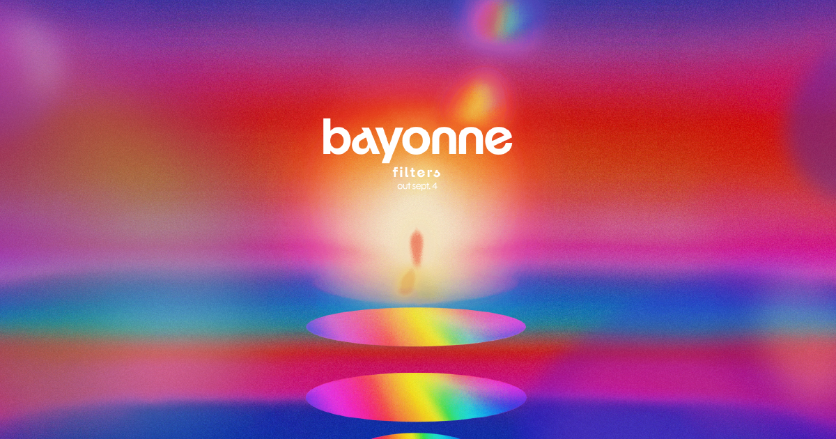 Bayonne’s Filters artwork, with the album title above a small silhouetted figure and glowing rainbow ovals in a blurred pink, orange, blue and purple landscape