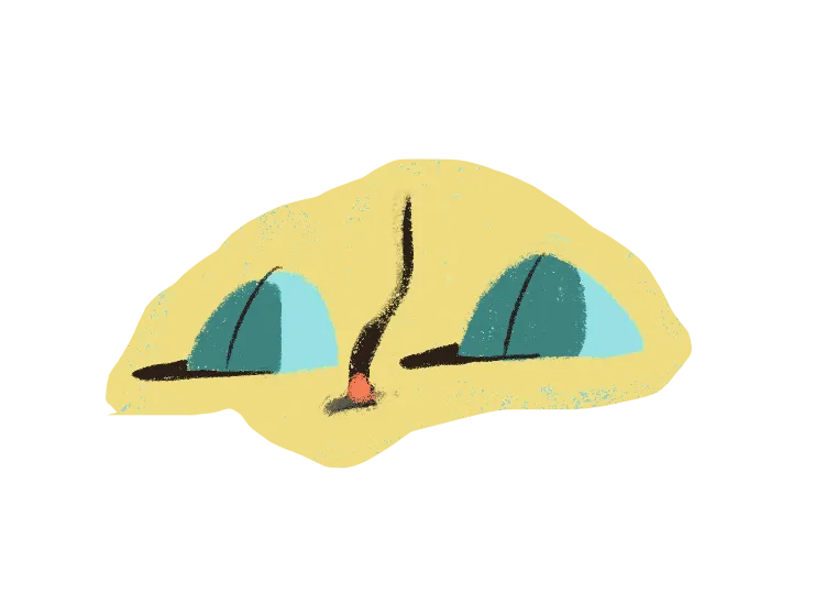 Two green camping tents set up in a sandy area with a small campfire between them.