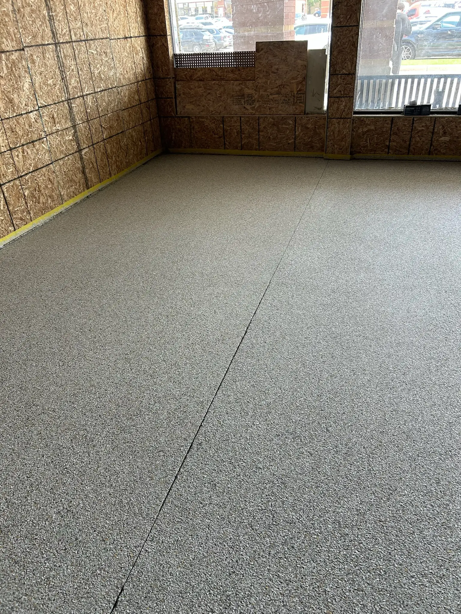 Epoxy floor in Vaughan automotive showroom with metallic finish