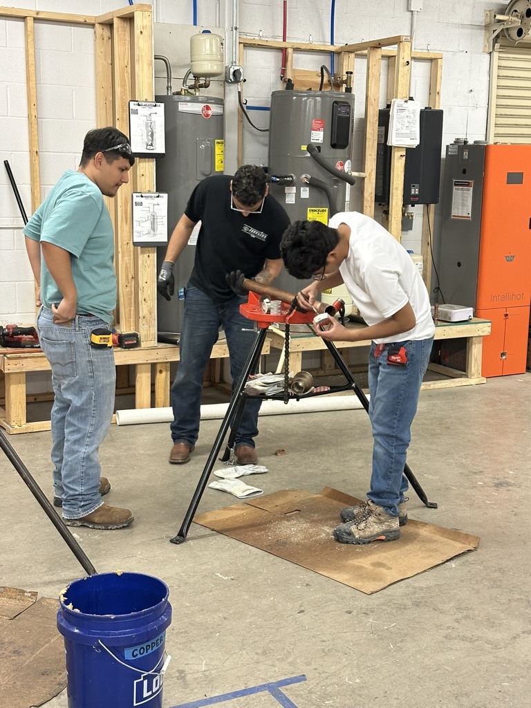 Students using power tools on training platform