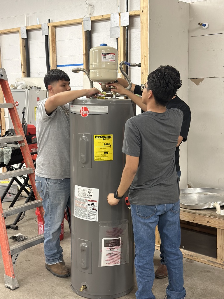 Student working on water heater installation