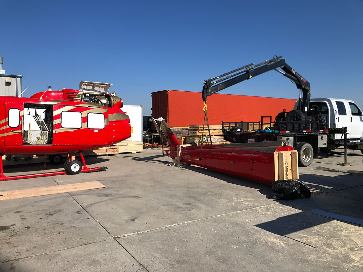 Forklift moving crated equipment at an on-site field location