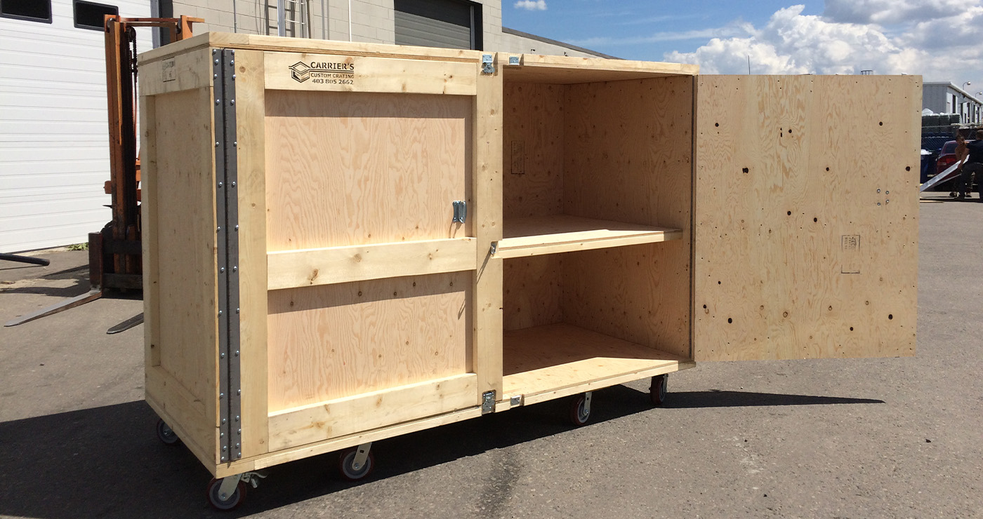 Carpenter assembling a custom industrial crate in the Carriers workshop