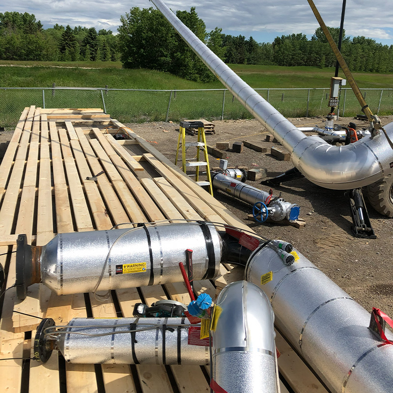 On-site crating crew packaging heavy equipment at an industrial facility