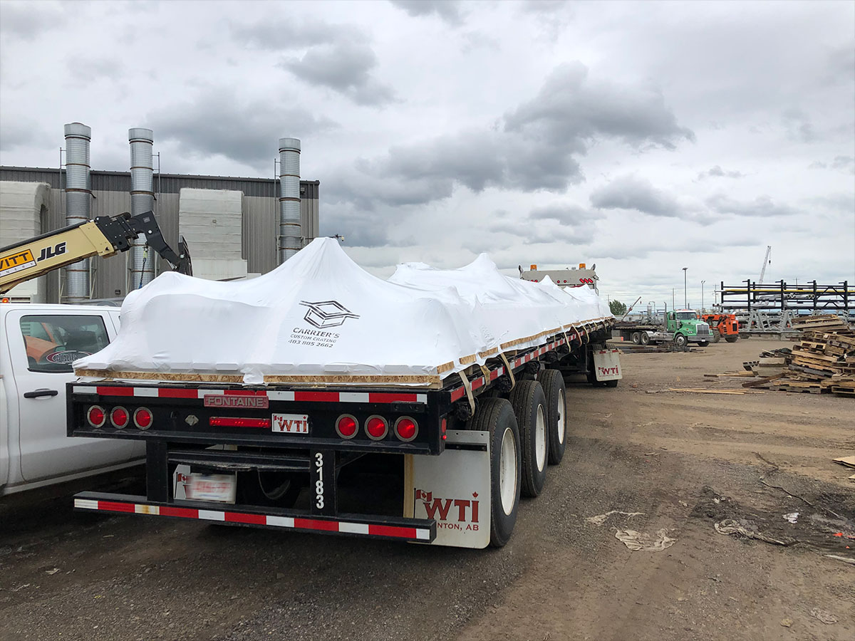 Equipment module fully wrapped in white industrial shrink film