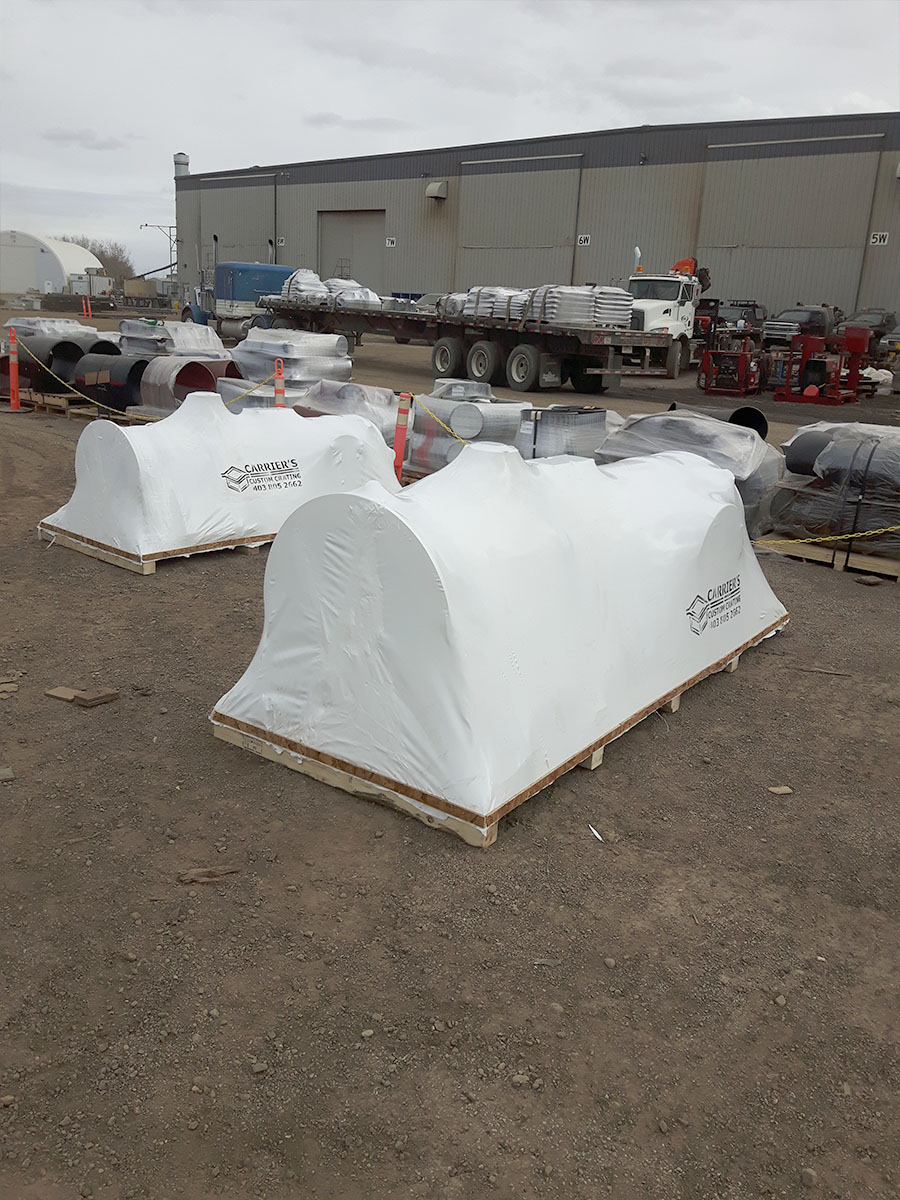 Field crew heat sealing shrink wrap around large industrial equipment