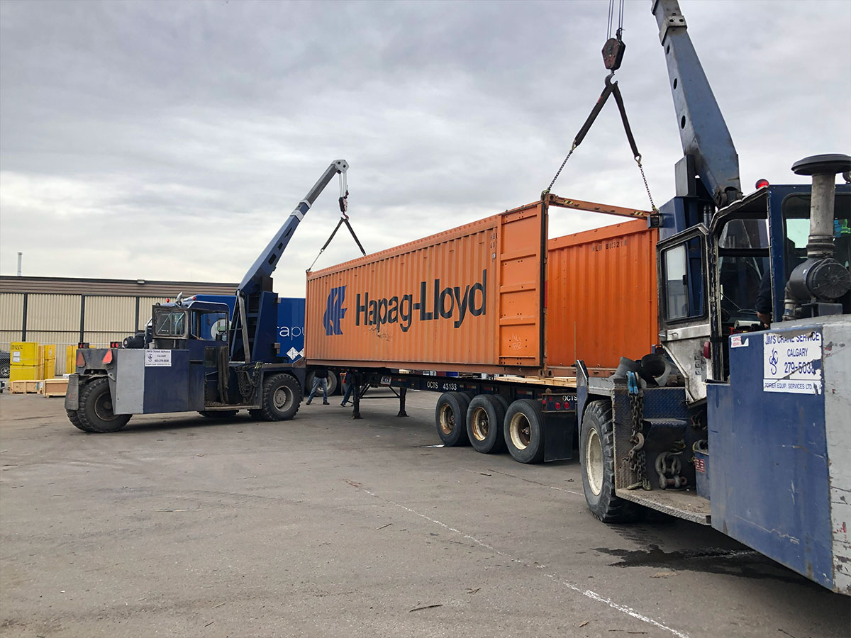 Container with shrink-wrapped cargo ready for port inspection