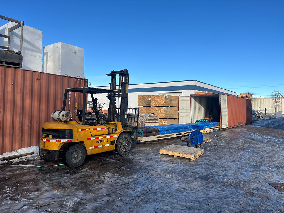 Carriers crew wrapping equipment inside a container for protection