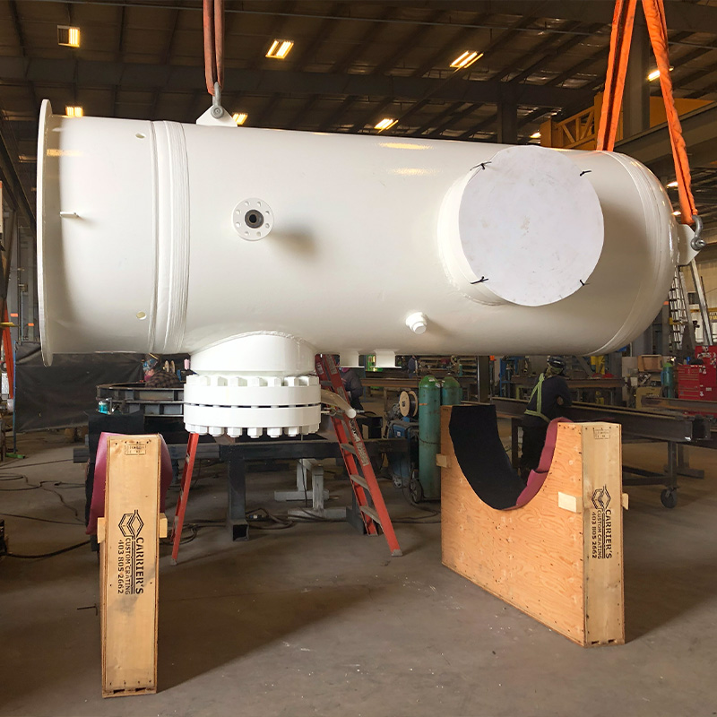 Custom shipping saddle cradling a large cylindrical industrial component