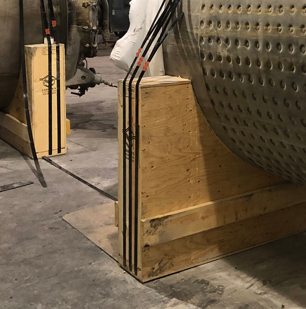 Multiple shipping saddles supporting an oversized industrial load