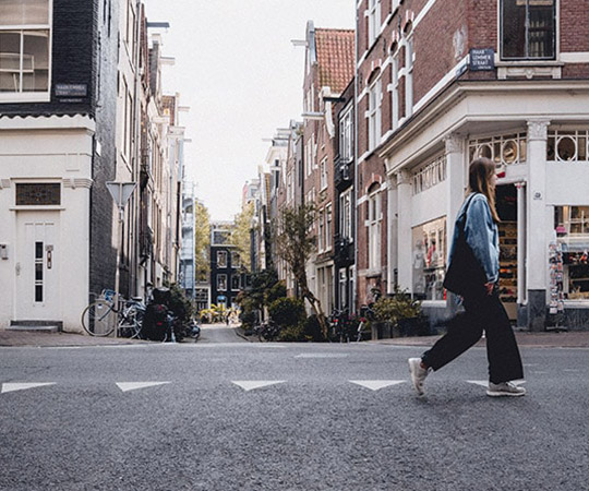 a person walking down a street in a city