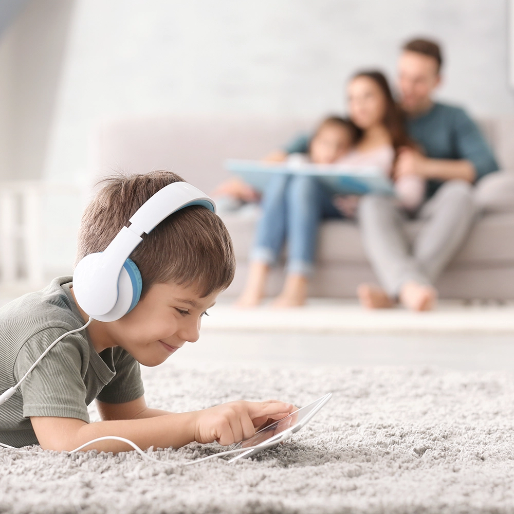 Kid playing with tablet on carpet flooring installed by Al American Discount Flooring.