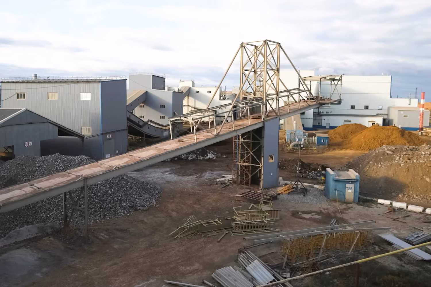 Mineral processing plant with conveyor systems and material handling infrastructure.