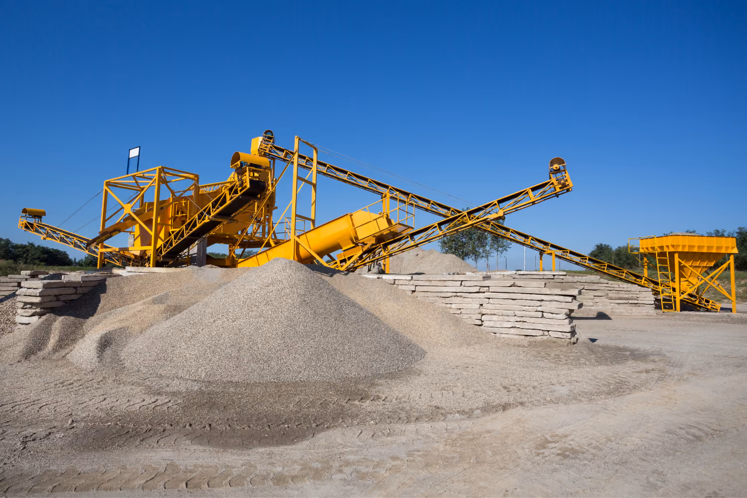 Quarry processing equipment handling aggregate and raw construction materials.
