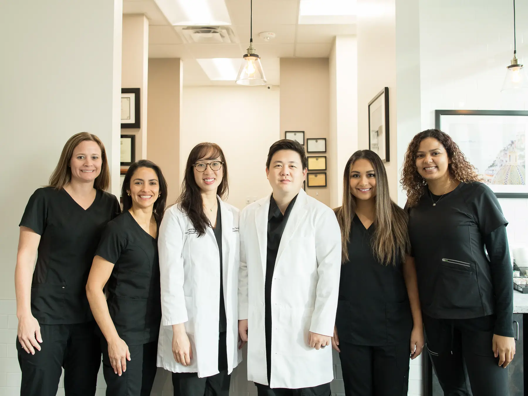 Grand Mission Dentistry doctors and dental team standing together in the Richmond, TX office