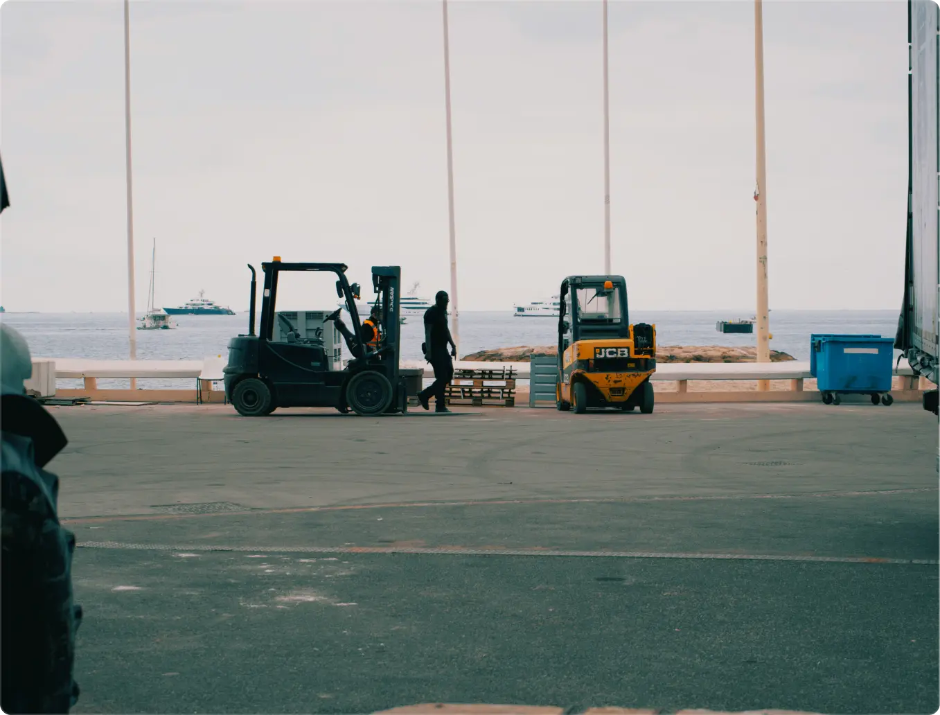 Orange smiley face and white text reading 'STAY SAFE' painted on rough asphalt pavement.