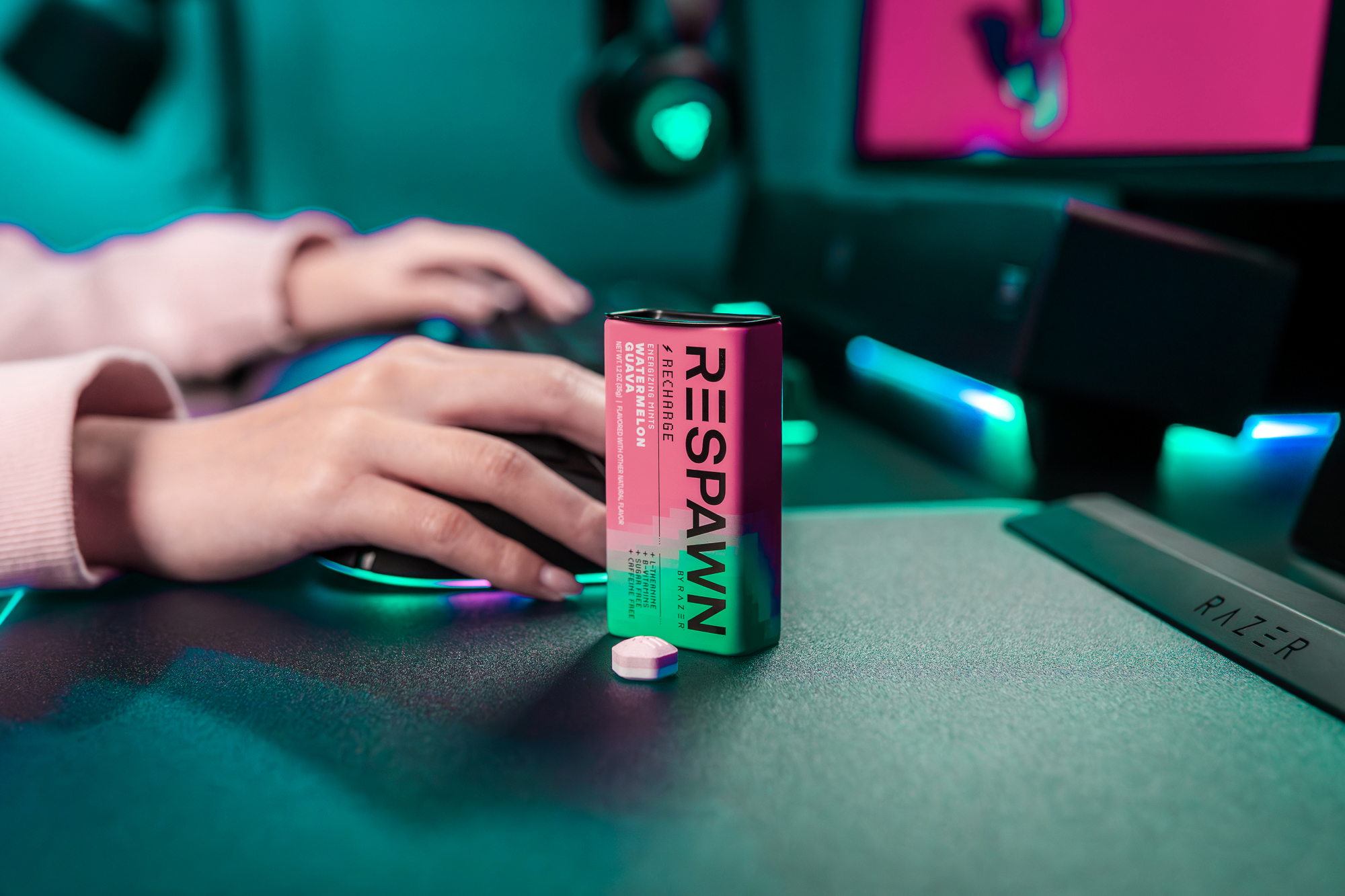 A lifestyle photo of someone using their computer with a tin of mints on their table.