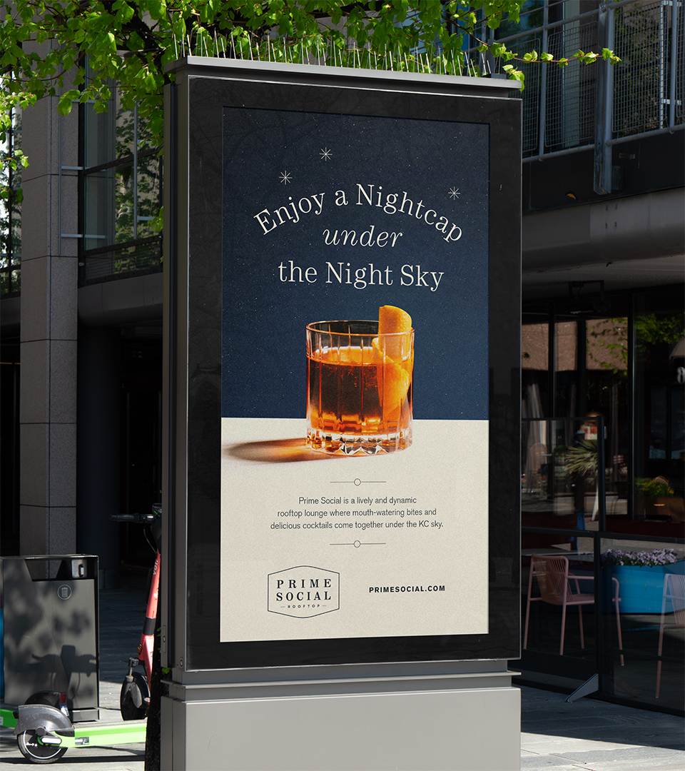 Advertisement on a street kiosk showing a glass of cocktail with an orange peel garnish, promoting Prime Social rooftop lounge.