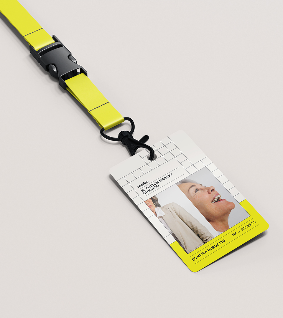 Identification badge with a yellow lanyard showing a photo of a smiling woman, text reading W. Fulton Market Chicago, and the name Cynthia Burdette with HR - Benefits department.