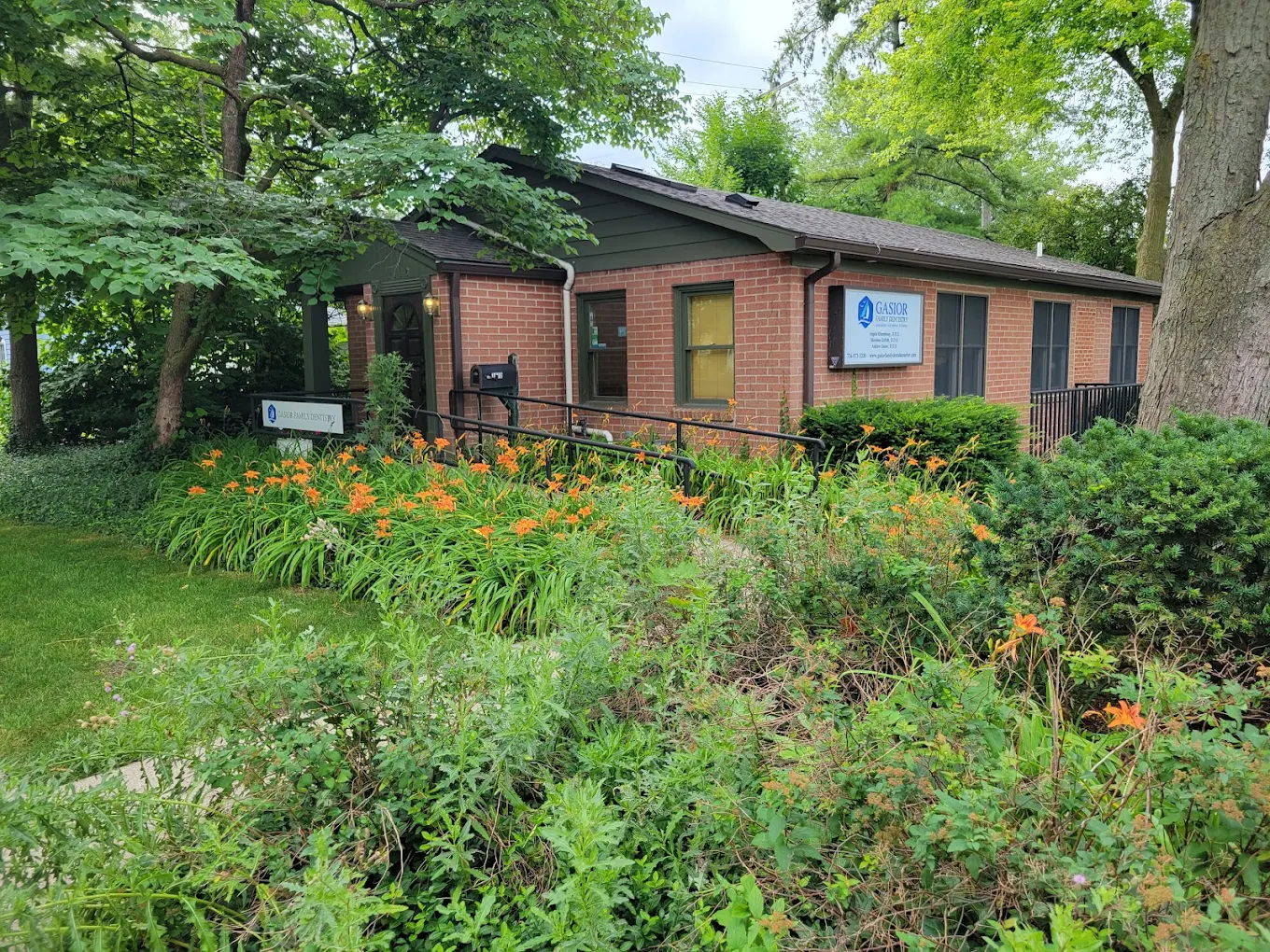 Exterior view of Gasior Family Dentistry in Ann Arbor, Michigan surrounded by trees and landscaping