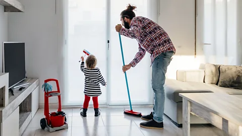 Getty Images Men helping tackle hidden household labour that disproportionately falls on women could help lighten the load on mums, and create more equal households (Credit: Getty Images)