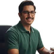 Smiling man with glasses and mustache wearing a green polo shirt sitting at a desk.