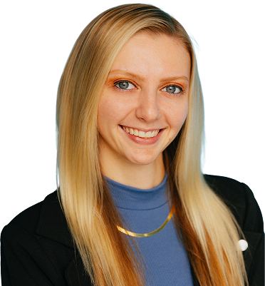 Smiling blonde woman wearing a dark blazer and a gold necklace.