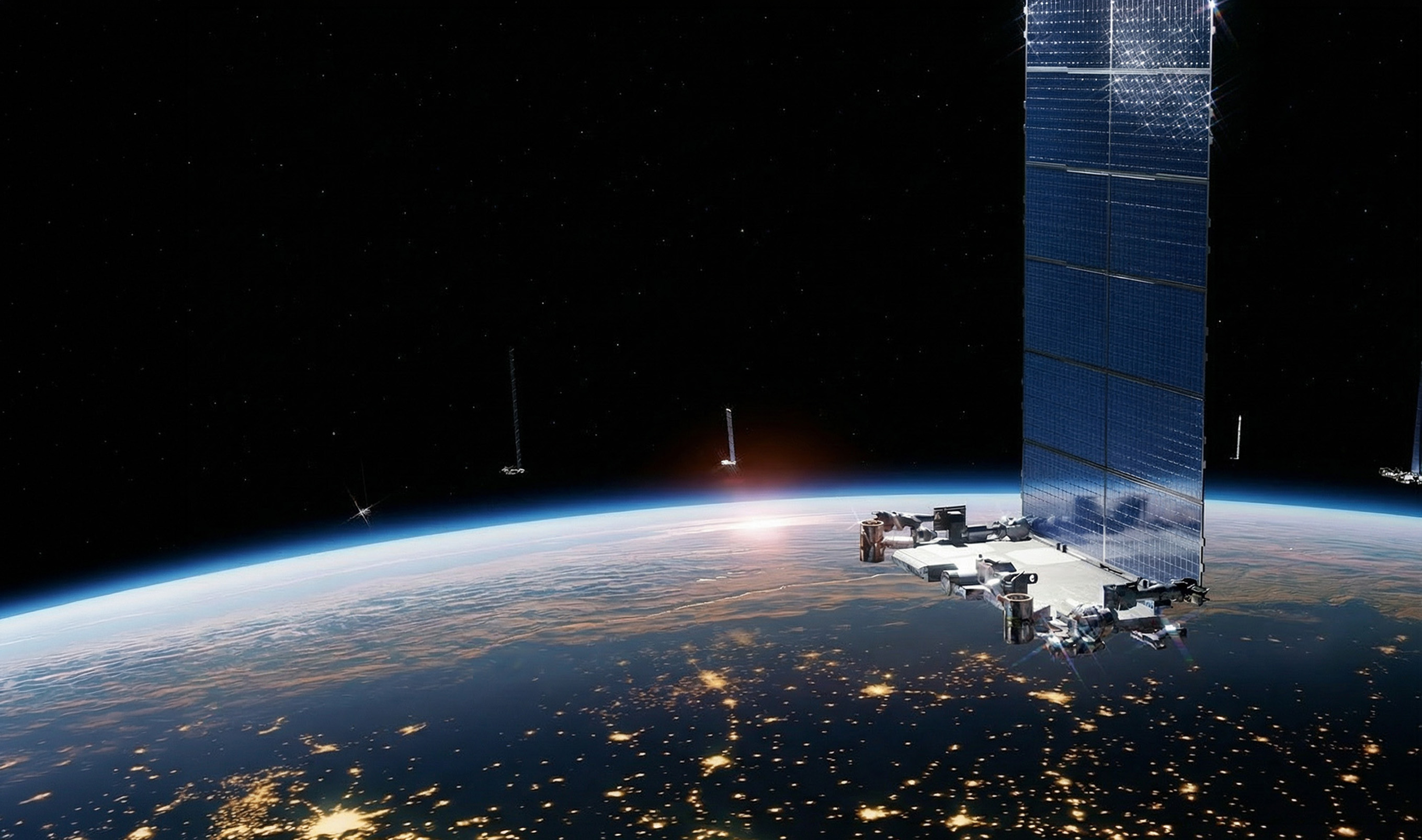 Large satellite with solar panels orbiting Earth at sunrise, with city lights visible on the dark side of the planet.