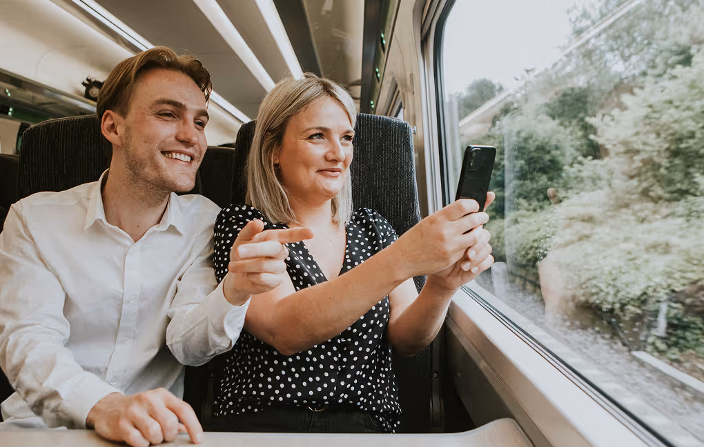 Arrival moment: Guests smiling and enjoying the journey inside a train.