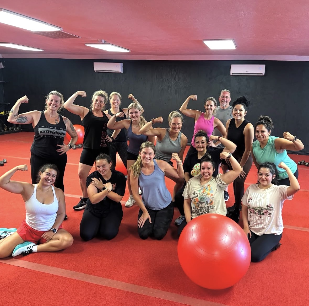 A group of people posing after a workout at JAB Fitness