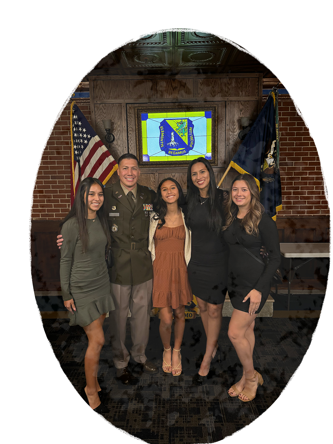 An army Warrant Officer standing with his family at the Fort Leonard Wood CBRN Museum.