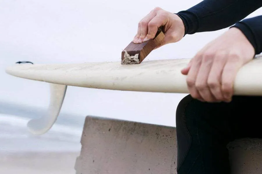 waxing surfboard