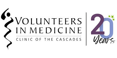 Volunteers in Medicine Clinic of the Cascades logo with stylized figure and '20 Years' anniversary text.