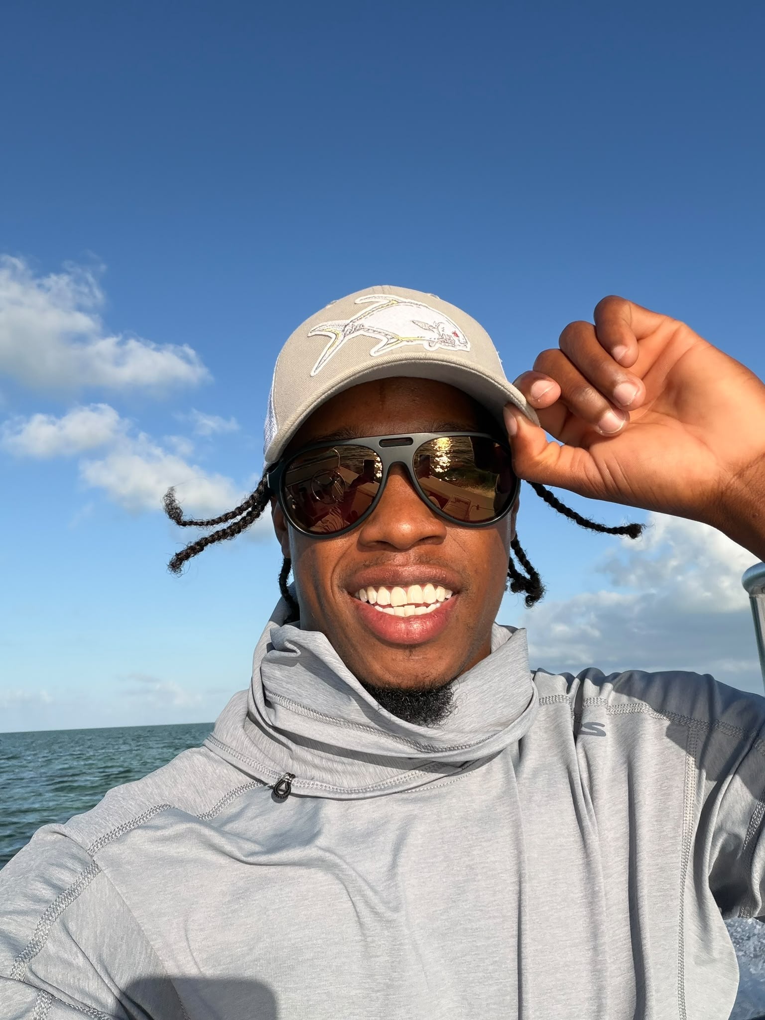 LJ Bean smiling on the skiff in a Soul Fly Lodge hat