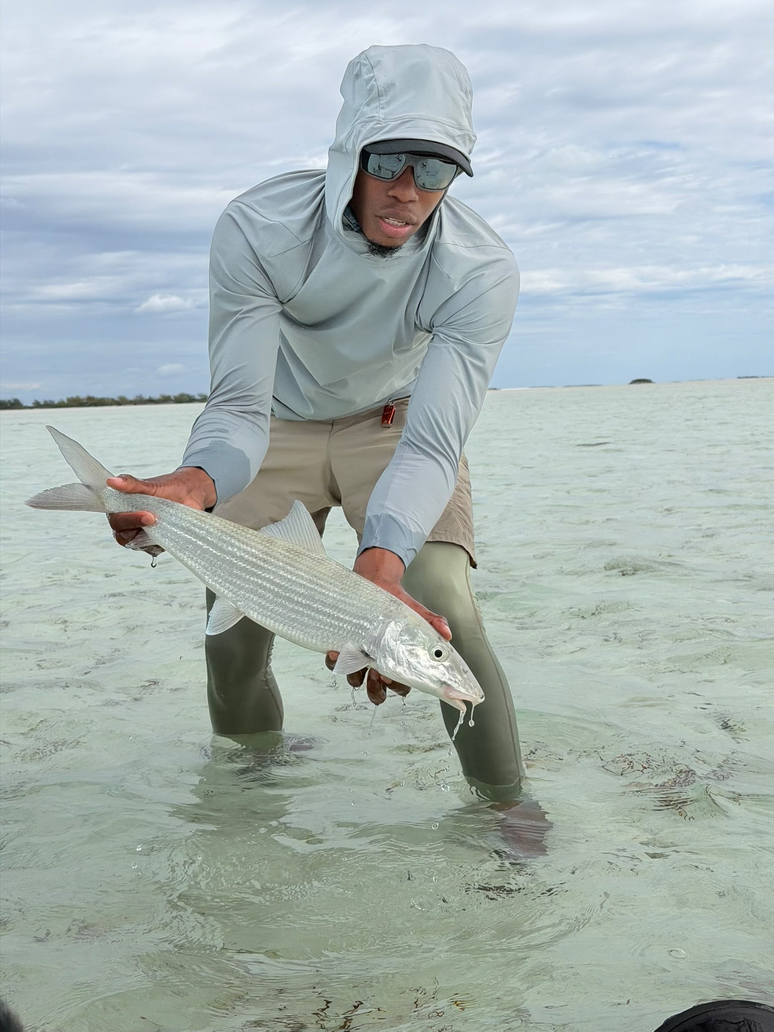 LJ Bean releasing a bonefish on a shallow Berry Islands flat