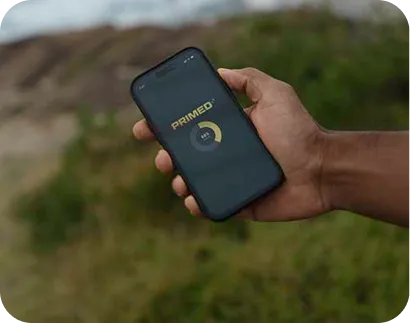 Hand holding a smartphone displaying the PRIMED app with a circular progress indicator at 40%.