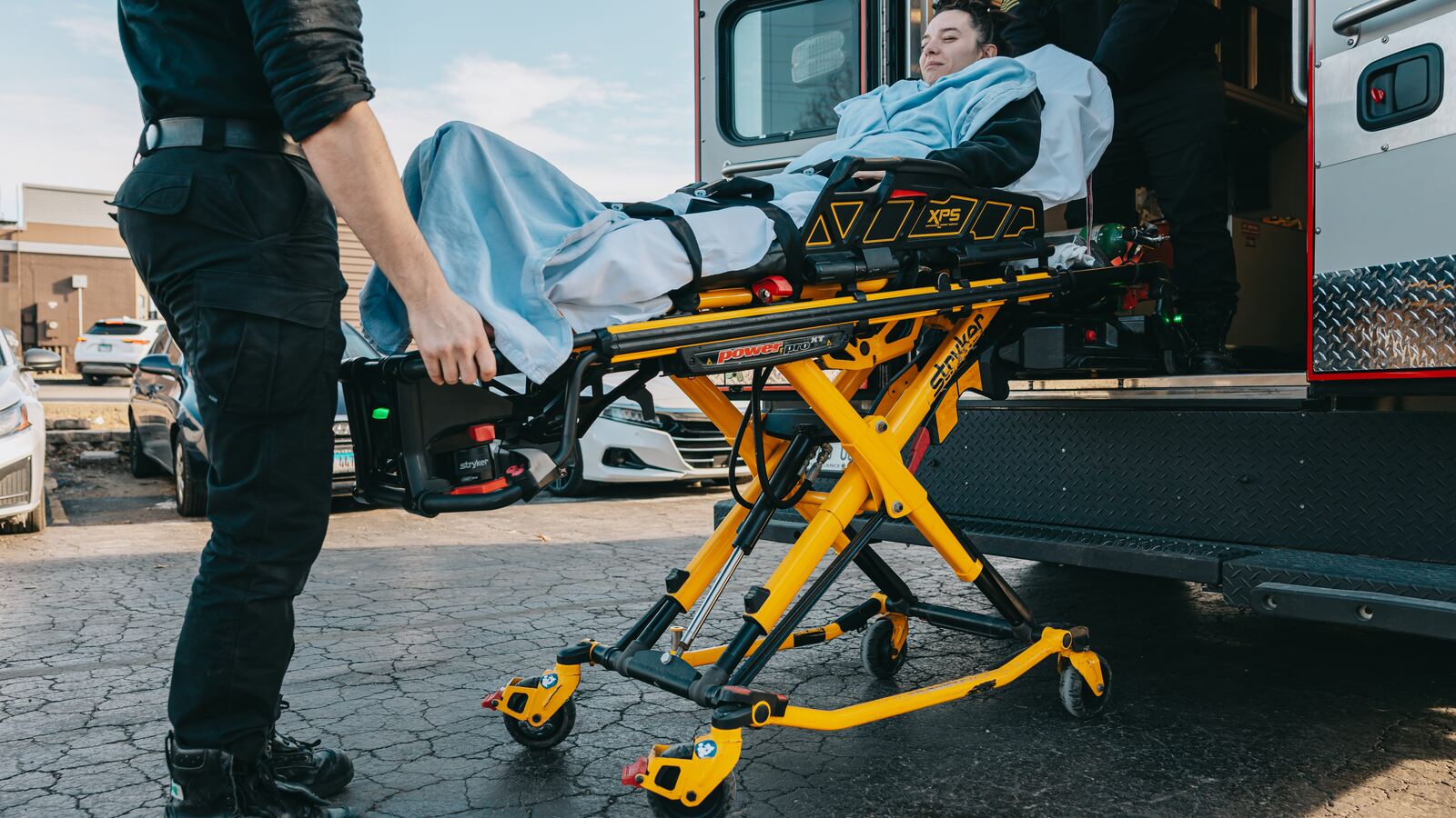 Northwest Rescue crew loading a patient on a stretcher into an ambulance during interfacility transport operations in Illinois.