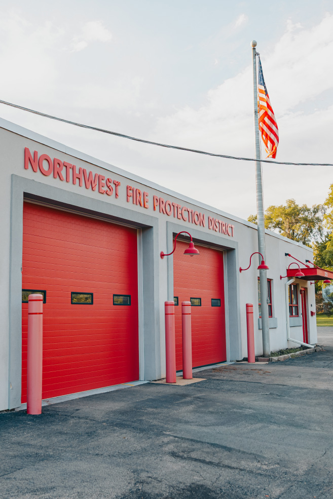 Red bay doors and American flag at the Northwest Rescue Rockford Westside station